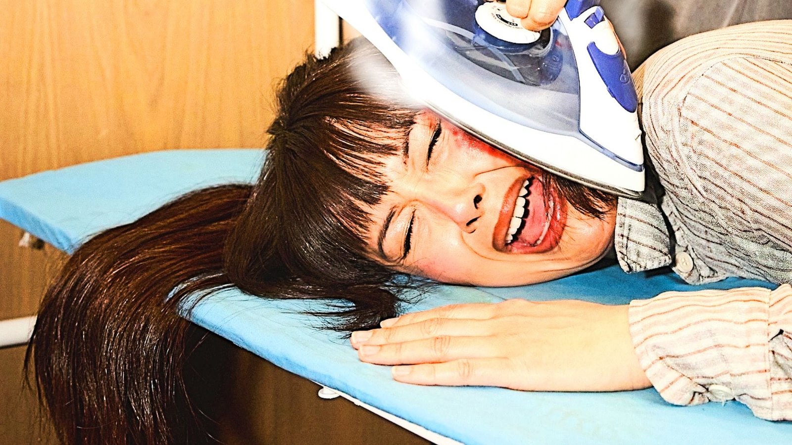 Promo image of Patti Harrison's face getting ironed